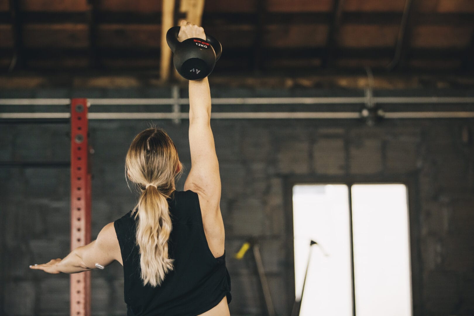 woman lifting weights at at Albany Movement & Fitness